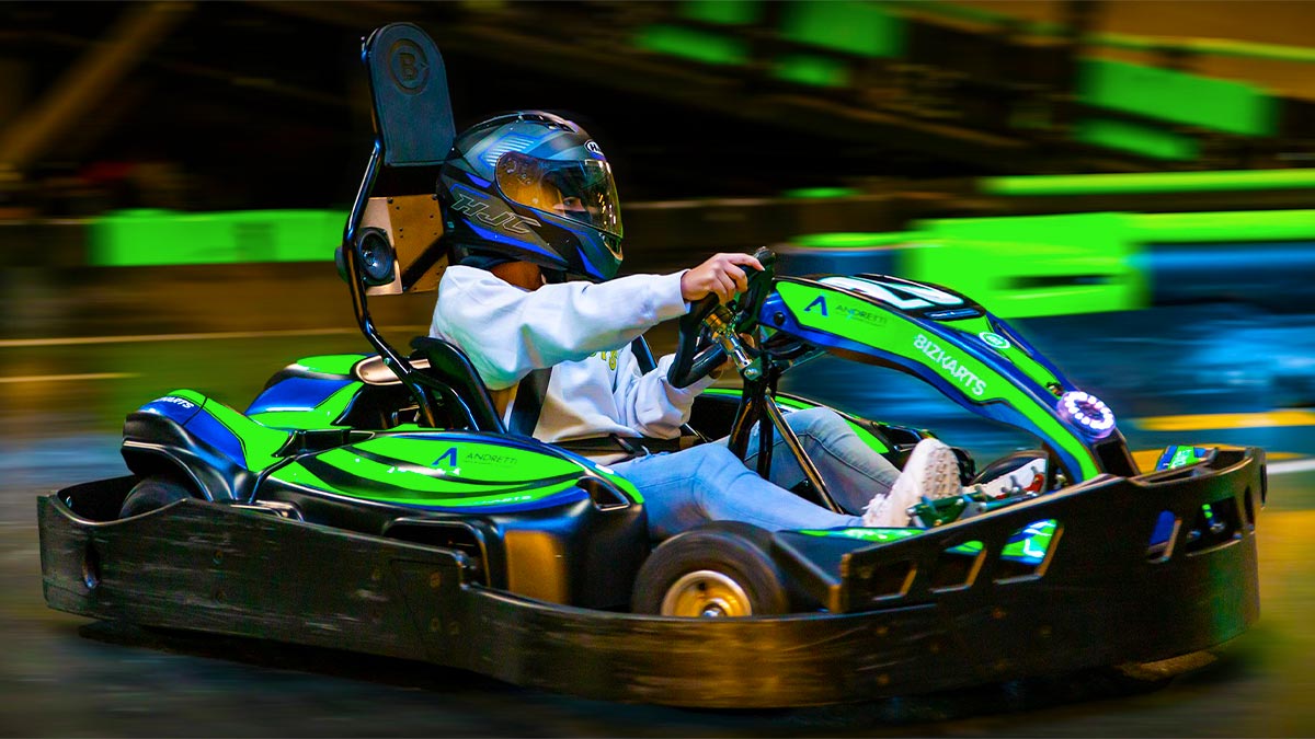 A man doing indoor karting.